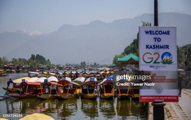 Shikara boats are moored next to a sign at Dal lake ahead of the G20 summit on May 21, 2023 in Srinagar, Indian administered Kashmir, India. The...