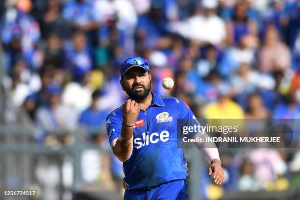 Mumbai Indians' Rohit Sharma throws the ball during the Indian Premier League Twenty20 cricket match between Mumbai Indians and Sunrisers Hyderabad...