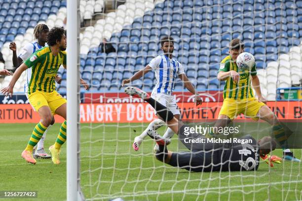 Dara O'Shea of West Bromwich Albion scores his team's first goal past Jonas Loessl of Huddersfield Town during the Sky Bet Championship match between...