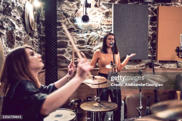 female singer and drummer making a song in the studio sound epic - hitting drum stock pictures, royalty-free photos & images