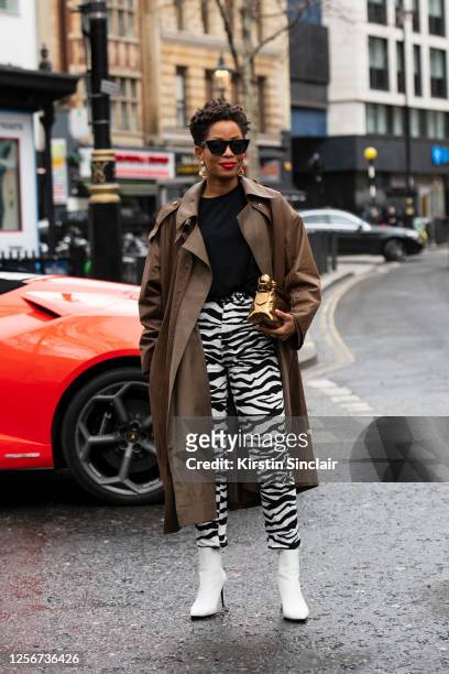 Digital influencer Ellie Delphine wears a Low Classic jacket, The Attico trousers, Dries Van Noten bag, Charles and Keith boots, Celine sunglasses,...