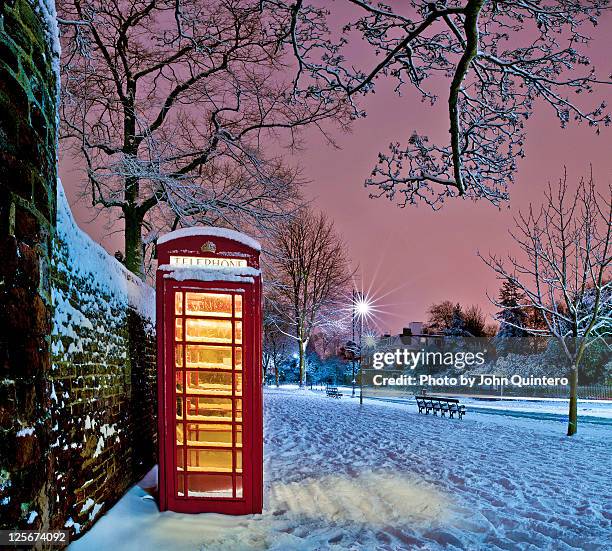 red phone box covered in snow - hampstead london stock pictures, royalty-free photos & images