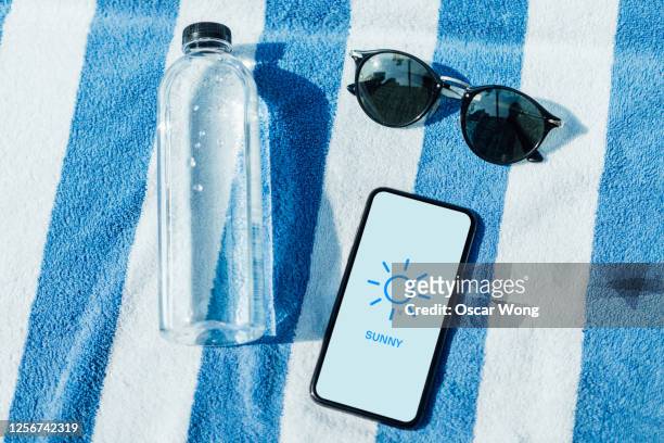concept of summer vacation in swimming pool - striped towel stock pictures, royalty-free photos & images