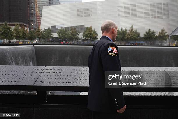 New York City firefighter looks for the names of colleagues killed on September 11, 2001 during a first responders wreath-laying ceremony at the...