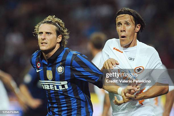 Diego Forlan of FC Internazionale Milano competes with Rodrigo Taddei of AS Roma during the Serie A match between FC Internazionale Milano and AS...