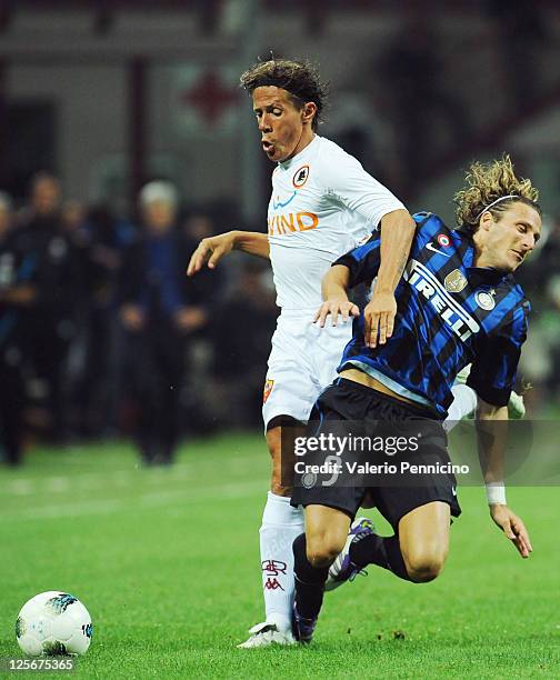 Diego Forlan of FC Internazionale Milano clashes with Rodrigo Taddei of AS Roma during the Serie A match between FC Internazionale Milano and AS Roma...