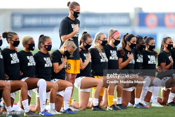 Nicole Barnhart of the Utah Royals FC stands as others teammates kneel during the national anthem prior to the quarterfinal match against the Houston...