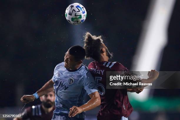 Roger Espinoza of Sporting Kansas City and Auston Trusty of Colorado Rapids battle for a header during a Group D match as part of the MLS Is Back...
