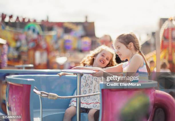 two girls at a fairground - fairground ride stock pictures, royalty-free photos & images