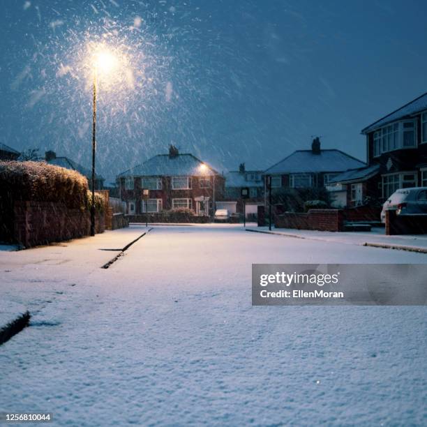 snow covered residential road - snow road stock-fotos und bilder