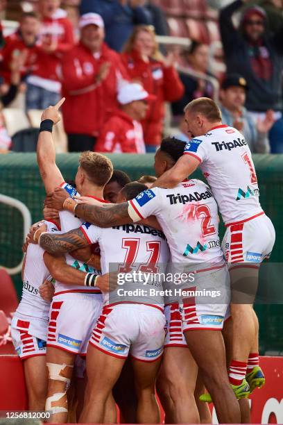 Corey Norman of the Dragons celebrates scoring a try with team mates during the round 10 NRL match between the St George Illawarra Dragons and the...