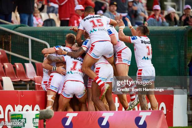 Corey Norman of the Dragons celebrates scoring a try with team mates during the round 10 NRL match between the St George Illawarra Dragons and the...