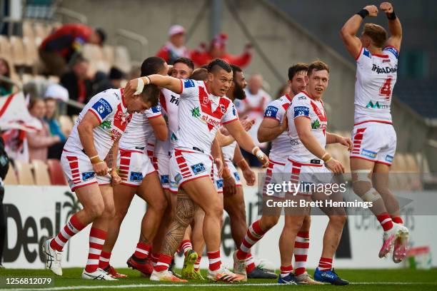 Corey Norman of the Dragons celebrates scoring a try with team mates during the round 10 NRL match between the St George Illawarra Dragons and the...