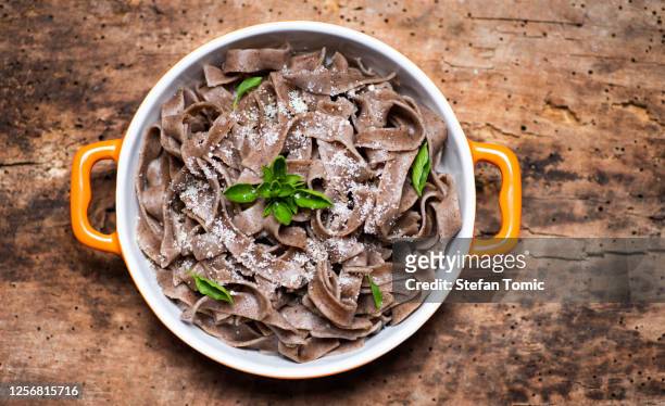 buckwheat pasta with parmesan and basil - buckwheat stock pictures, royalty-free photos & images