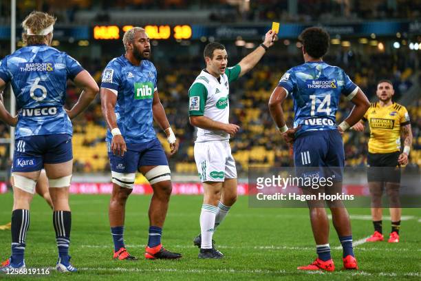 Referee Ben O'Keeffe shows a yellow card to Emoni Narawa of the Blues during the round 6 Super Rugby Aotearoa match between the Hurricanes and the...