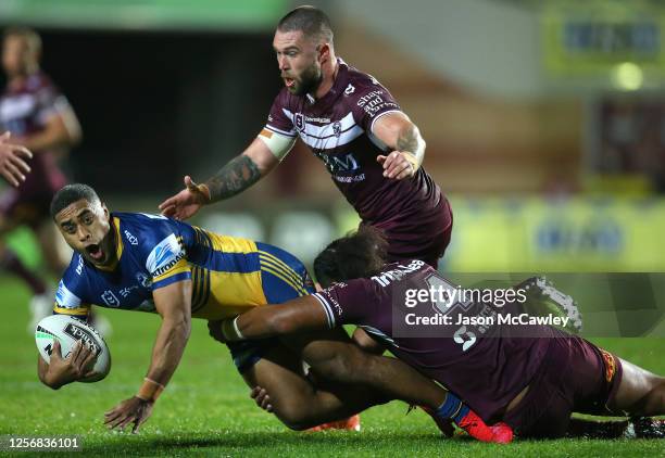 Michael Jennings of the Eels is tackled during the round 10 NRL match between the Manly Sea Eagles and the Parramatta Eels at Lottoland on July 18,...