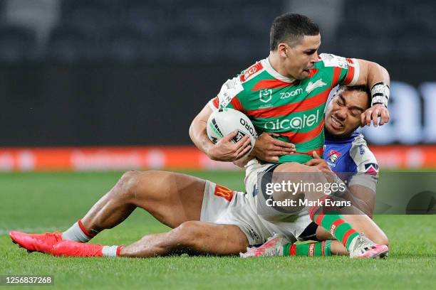 Cody Walker of Souths is tackled during the round 10 NRL match between the South Sydney Rabbitohs and the Newcastle Knights at Bankwest Stadium on...