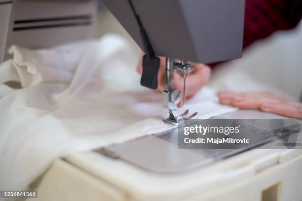 tailor at work on sewing machine - needlecraft product stock pictures, royalty-free photos & images