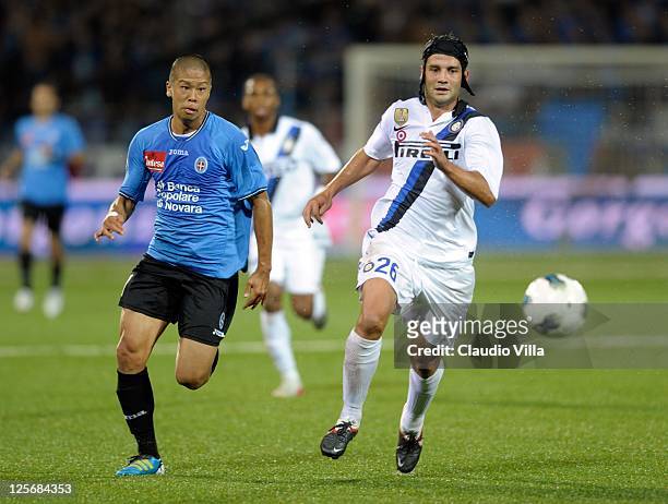 Takayuki Morimoto of Novara Calcio competes for the ball with Cristian Chivu of FC Inter Milan during the Serie A match between Novara Calcio and FC...