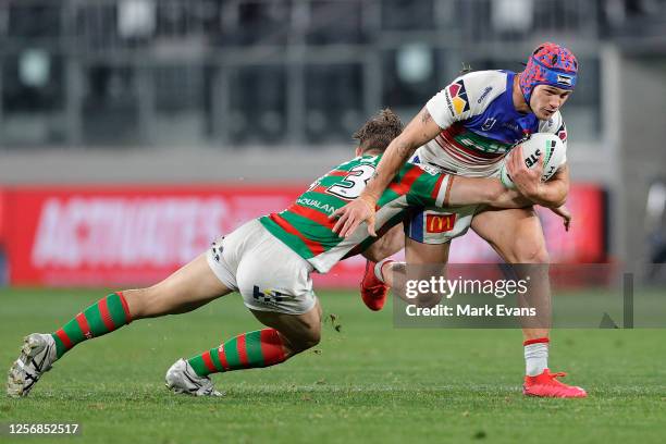 Kalyn Ponga of the Knights is tackled during the round 10 NRL match between the South Sydney Rabbitohs and the Newcastle Knights at Bankwest Stadium...