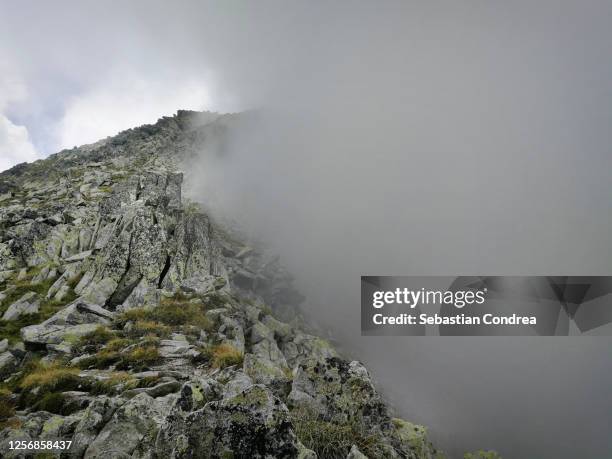 mountain ridge in gray strom clouds romanian carpathia, retezat mountains, romania - alps romania stock pictures, royalty-free photos & images