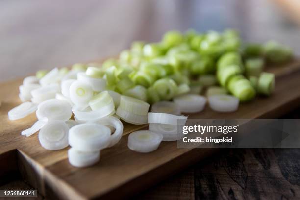 chopped spring onions on wooden cutting board - scallion stock pictures, royalty-free photos & images