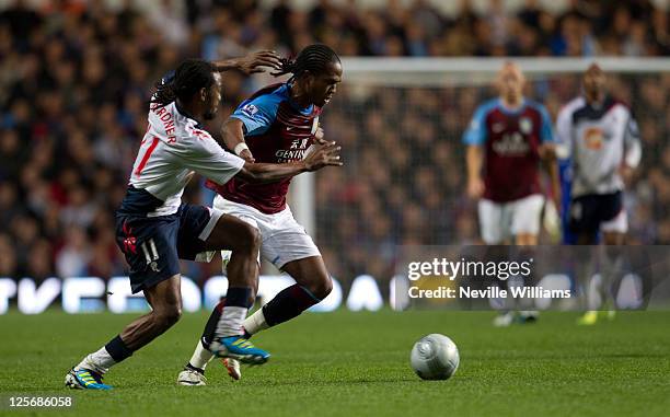 Nathan Delfounseo of Aston Villa challenged by Ricardo Gardener of Bolton Wanderers during the Carling Cup third round match between Aston Villa and...