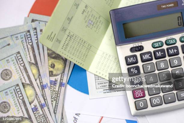 debt collection and tax season concept with deadline calendar remind note,coins,banks,calculator on table, background ,time to pay concept - debt collector stock-fotos und bilder