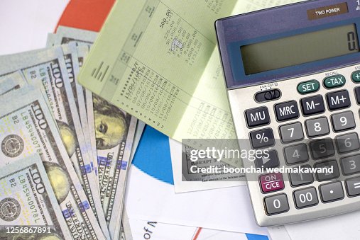 debt collection and tax season concept with deadline calendar remind note,coins,banks,calculator on table, background ,time to pay concept