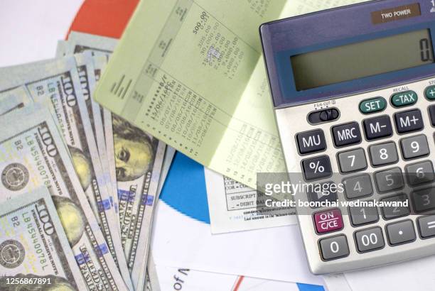 debt collection and tax season concept with deadline calendar remind note,coins,banks,calculator on table, background ,time to pay concept - income tax bildbanksfoton och bilder