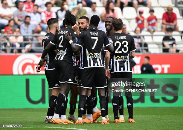 Angers' Bosnian defender Halid Sabanovic celebrates with teammates after scoring his team's first goal during the French L1 football match between...