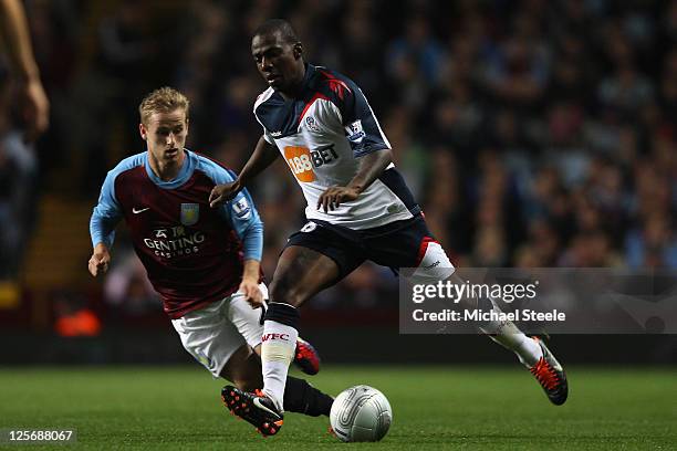 Gael Kakuta of Bolton Wanderers watched by Barry Bannan of Aston Villa during the Carling Cup third round match between Aston Villa and Bolton...