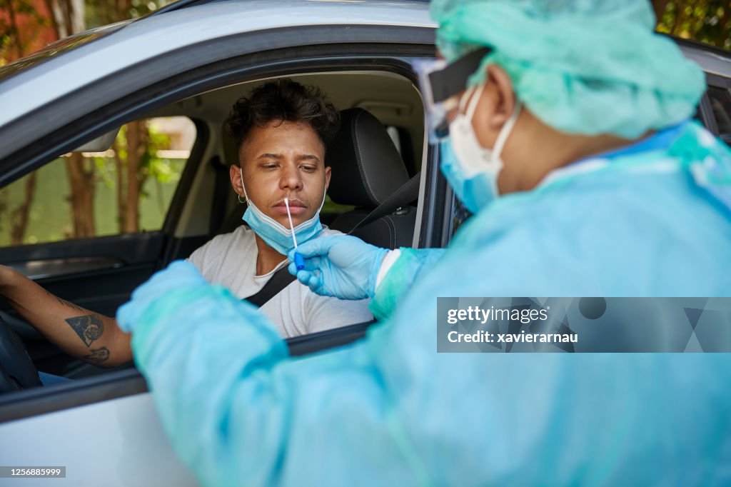Concerned Man Getting COVID-19 Nasal Swab Test at Drive-Thru
