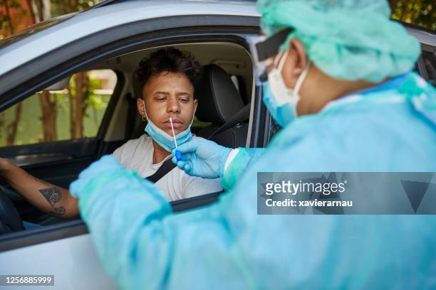 Concerned Man Getting COVID-19 Nasal Swab Test at Drive-Thru