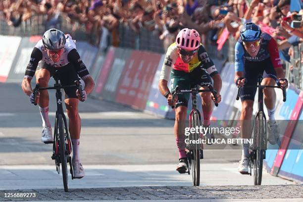 Team Emirates's US rider Brandon McNulty sprints in the last metters on his way to win, ahead of EF Education-EasyPost's Irish rider Ben Healy and...