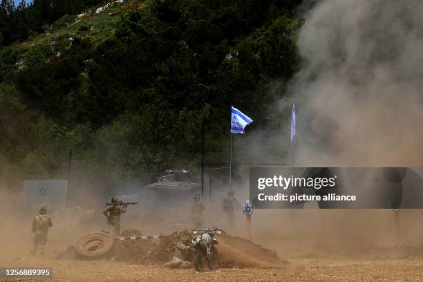 May 2023, Lebanon, Aramta: Pro-Iranian Hezbollah fighters conduct a simulation of attacking an Israeli post during a staged military exercise in a...