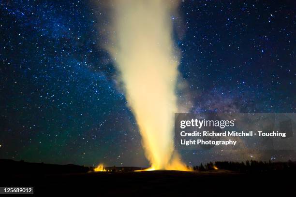 old faithful geyser and milky way - geysir stock-fotos und bilder