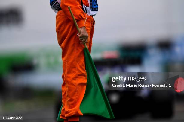 Track marshal holds a green flag during race one of the Formula 3 Championship at Hungaroring on July 18, 2020 in Budapest, Hungary.