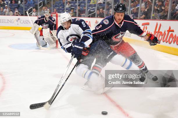 Evander Kane of the Winnipeg Jets battles for control of the puck with Marc Methot of the Columbus Blue Jackets on September 20, 2011 at Nationwide...