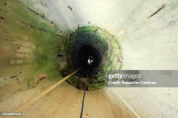 rural fountain tunnel, with reflection. - pozo agua fotografías e imágenes de stock