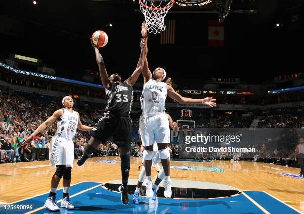 Taj McWilliams-Franklin of the Minnesota Lynx goes for the block against Sophia Young of the San Antonio Silver Stars in Game Three of the Western...