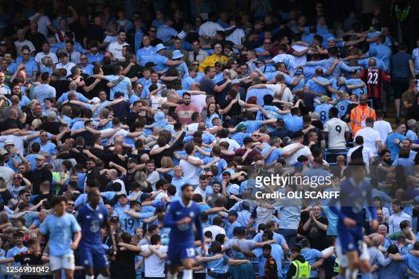 Manchester City fans do 'the Poznan' celebration during the English Premier League football match between Manchester City and Chelsea at the Etihad...