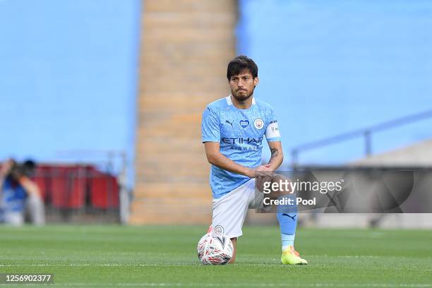David Silva of Manchester City takes a knee in support of the Black Lives Matter movement prior to the FA Cup Semi Final match between Arsenal and...