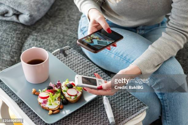 mid adult diabetic woman having breakfast at home - blood sugar test stock pictures, royalty-free photos & images