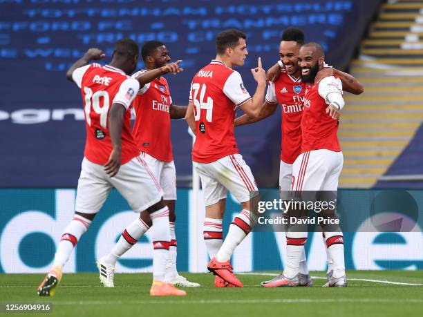 Pierre-Emerick Aubameyang celebrates scoring a goal for Arsenal with Alexandre Lacazette and their team mates during the FA Cup Semi Final match...