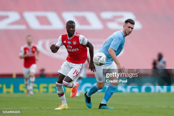 Nicolas Pepe of Arsenal and Aymeric Laporte of Manchester City chase the ball during the FA Cup Semi Final match between Arsenal and Manchester City...