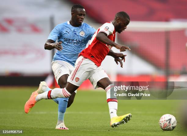 Nicolas Pepe of Arsenal takes on Benjamin Mendy of Man City during the FA Cup Semi Final match between Arsenal and Manchester City at Wembley Stadium...