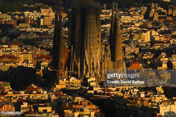 View of La Sagrada Familia stands over residential buildings during the first day the new Catalan government recommendations and regulations on the...