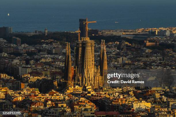 View of La Sagrada Familia stands over residential buildings during the first day the new Catalan government recommendations and regulations on the...