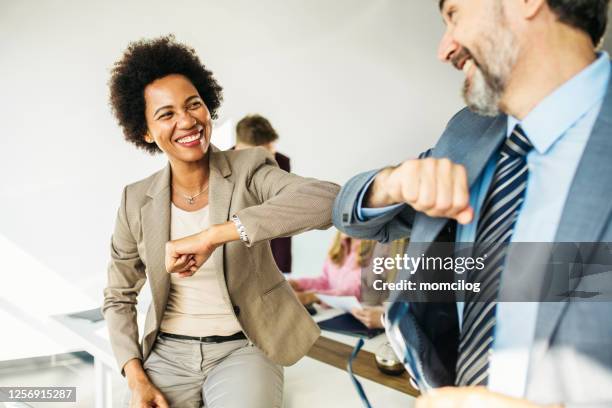 business people greeting during covid-19 - elbow greeting stock pictures, royalty-free photos & images